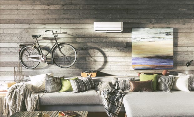 Modern living space with bike, sofa, and ductless split unit on shiplap wall | Homesense